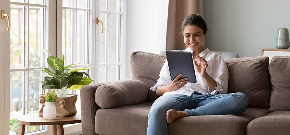 woman on couch easily logging into consumers energy website